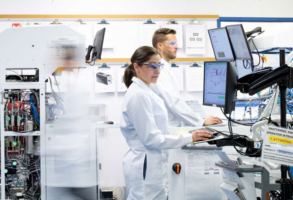 Scientists working on a PEM Fuel Cell Test Station